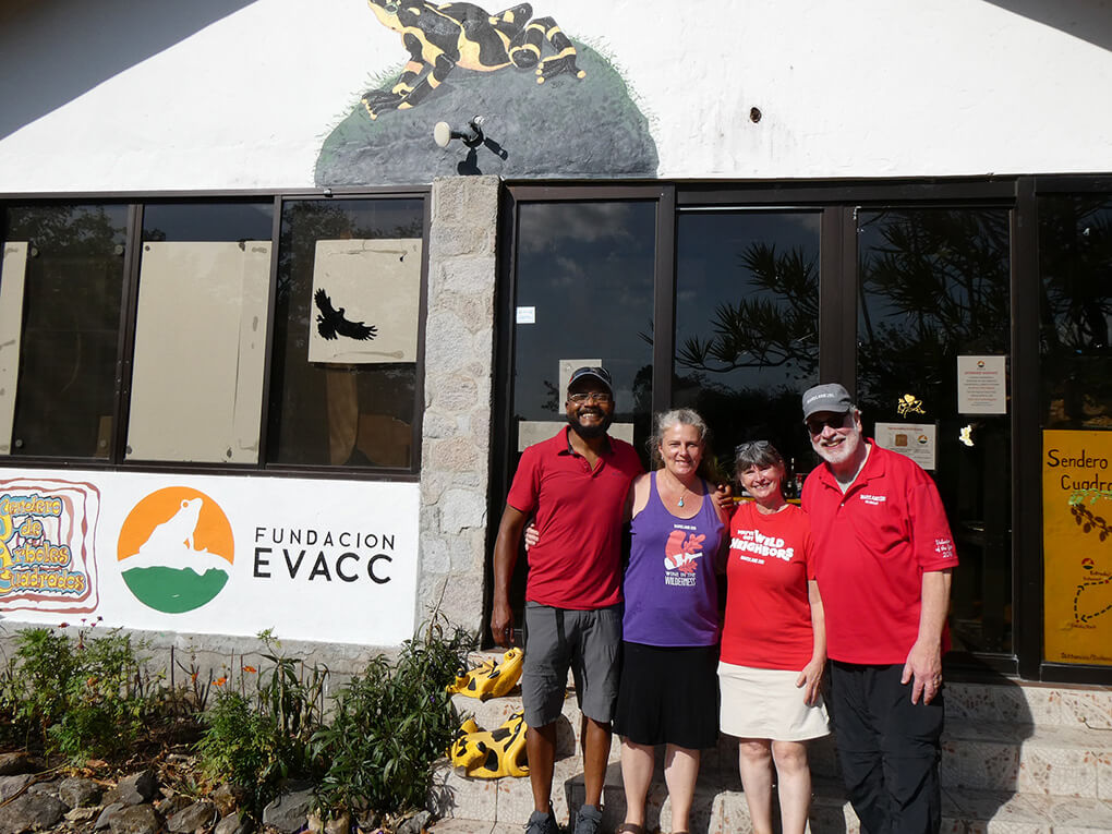 Four Zoo volunteers standing outside of a building, smiling for the camera.